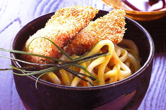 Sesame Crumbed Rainbow Trout On Wasabi Noodles in a bowl.
