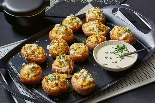 Smoked Trout And Chive Stuffed Potatoes on black tray.