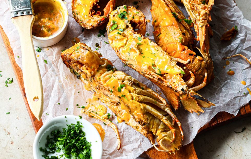 Grilled Moreton Bay Bugs with Sriracha Sauce on a tray.