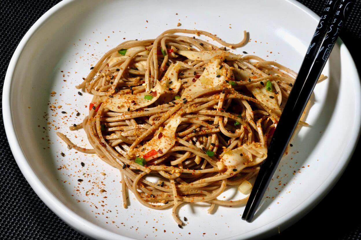 Abalone Sautéed With Soba Noodles in a white bowl.