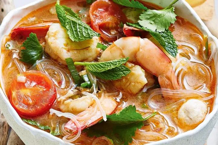 Banana Prawn Tom Yum presented in a white bowl.
