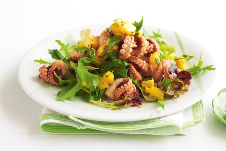 Barbecued Baby Octopus Salad With Mango Salsa And Chilli Lime Dressing on a plate.