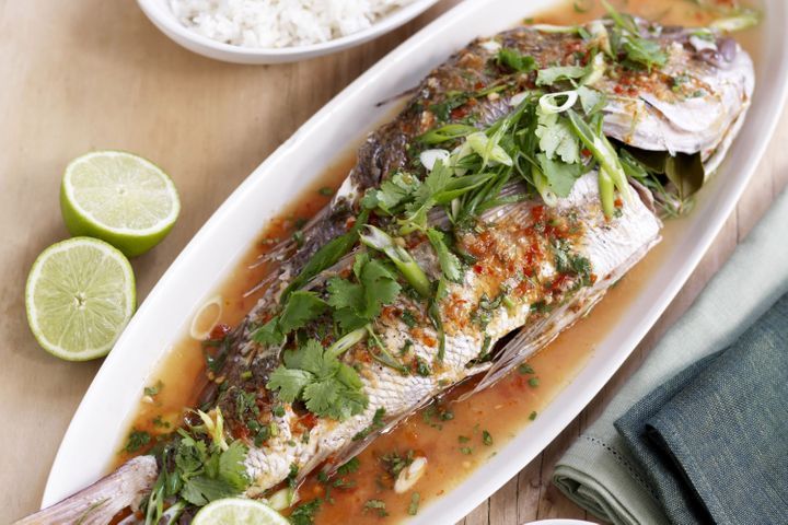 Barbecued Whole Snapper With Lime And Chilli on white platter.
