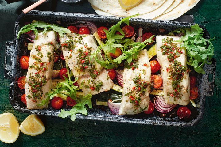 Barramundi Tray Bake With Chimichurri in black pan.