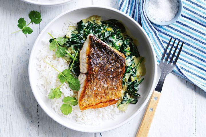 Barramundi With Coconut Creamed Spinach And Coriander in a bowl.