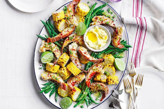BBQ Lobster With Corn And Ginger Butter on a white platter.