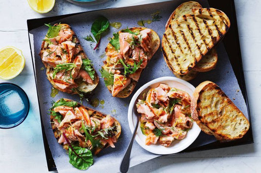 BBQ Salmon Bruschetta on black tray.