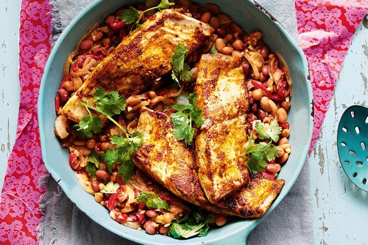Chermoula Kingfish with Moroccan Beans displayed on white plate.