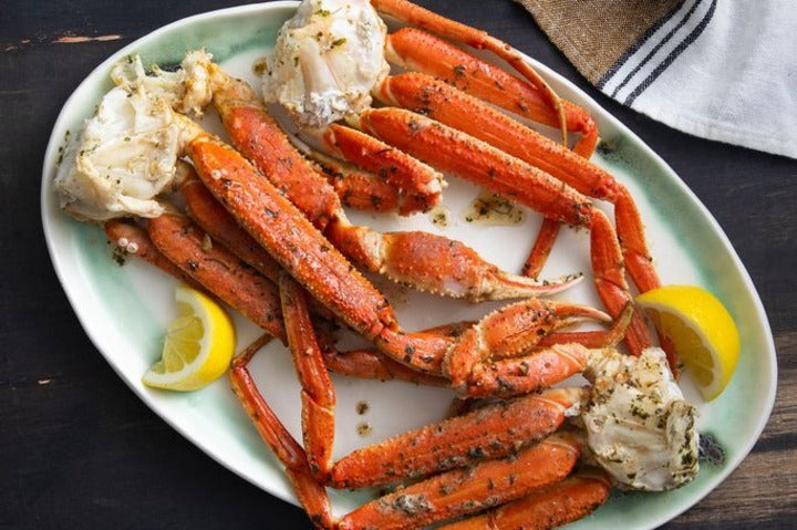 Crab Legs With Garlic Butter Sauce displayed on plate.