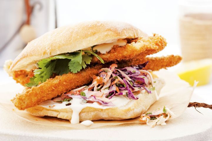 Crumbed Whiting Burgers With Cabbage Slaw And Coconut Mayo displayed on plate.
