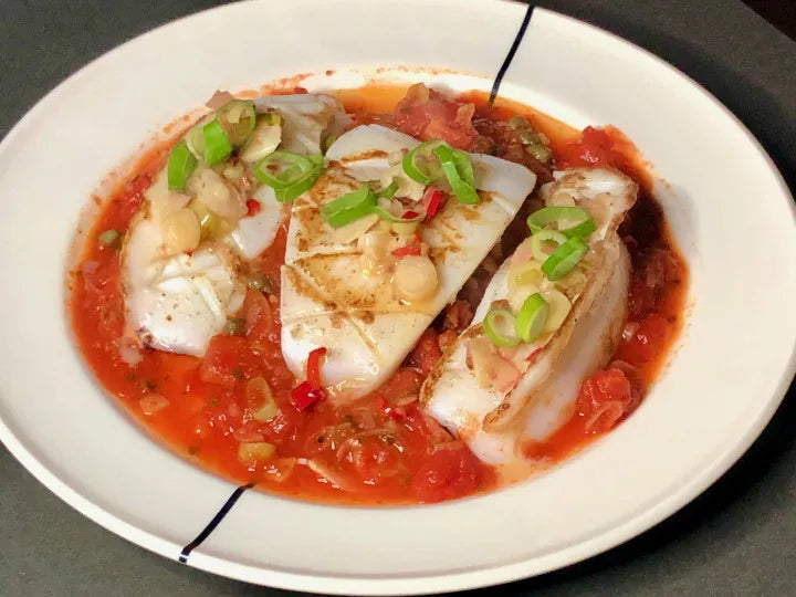Cuttlefish In Red And White served in a bowl.