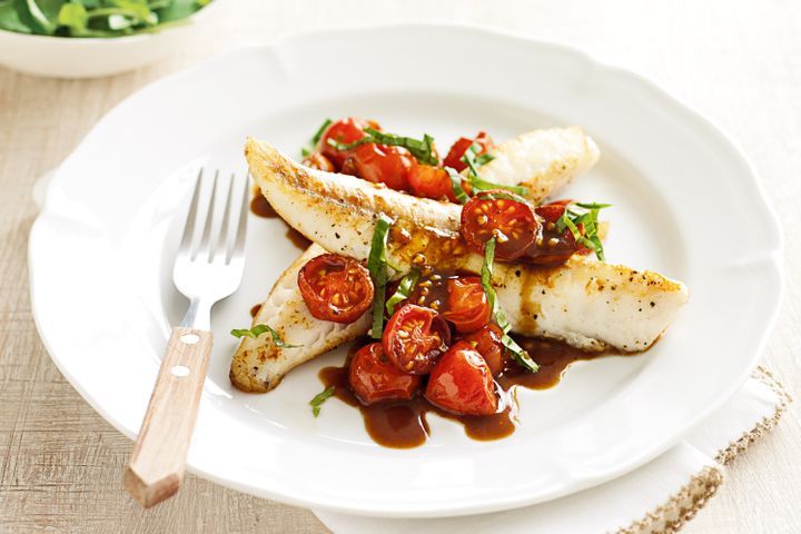 Flathead With Cherry Tomato Sauce displayed on plate.