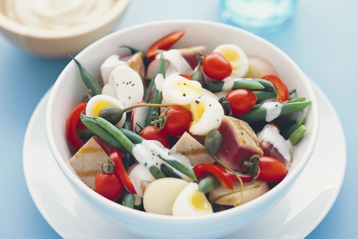 Fresh Tuna Nicoise Style Salad in white bowl.