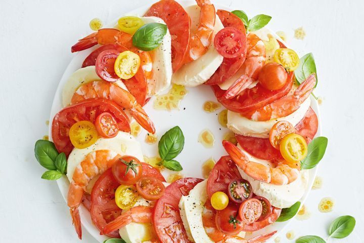Garlic Prawn Caprese Salad presented on white plate.
