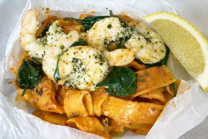 Garlic Prawn Pappardelle In A Bag in white bag.