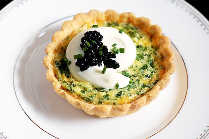 Herb And Creme Fraiche Tarts With Caviar on a plate.