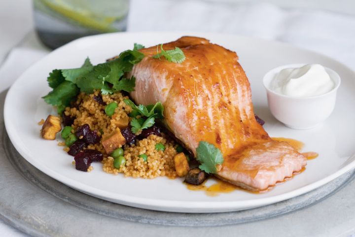 Jewelled Couscous With Ocean Trout displayed on a white plate.