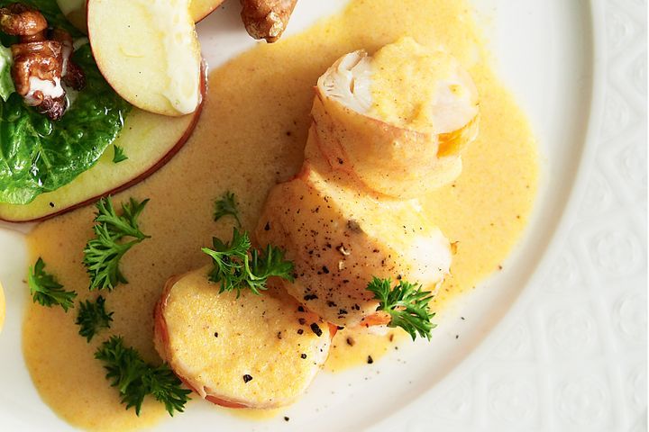 Lobster Newburg displayed on white plate.