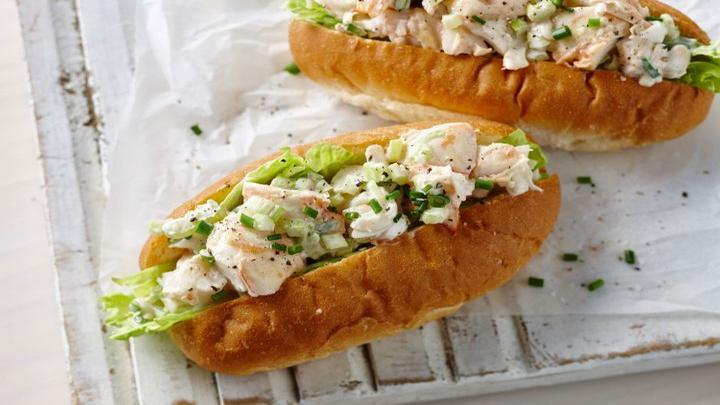 Lobster Roll on a rustic chopping board.