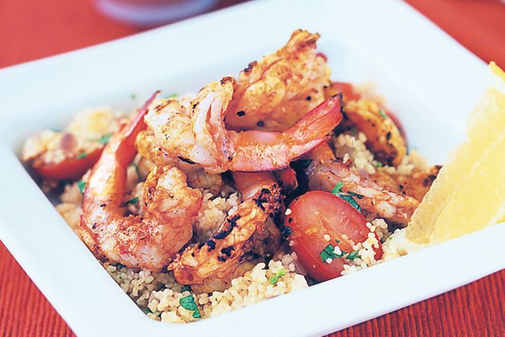 Moroccan Prawns With Tomato And Almond Couscous in white bowl.