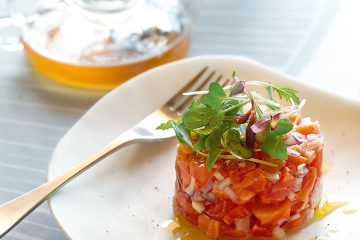 Ocean Trout Tartare With Tomato Tea presented on a plate.