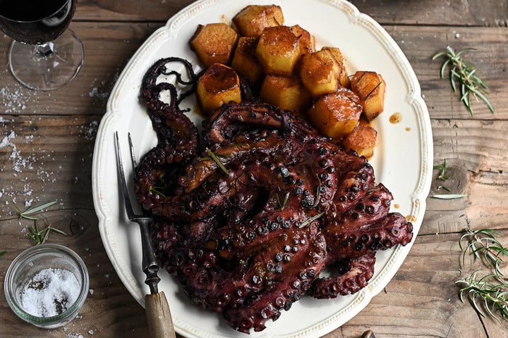 Octopus In Red Wine on a white plate.