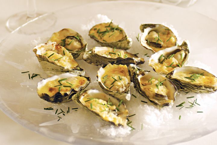 Oysters With Champagne Sauce on glass platter.