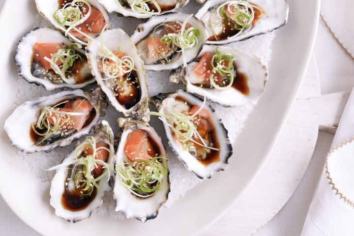 Oysters With Pickled Ginger Dressing presented on a white platter.