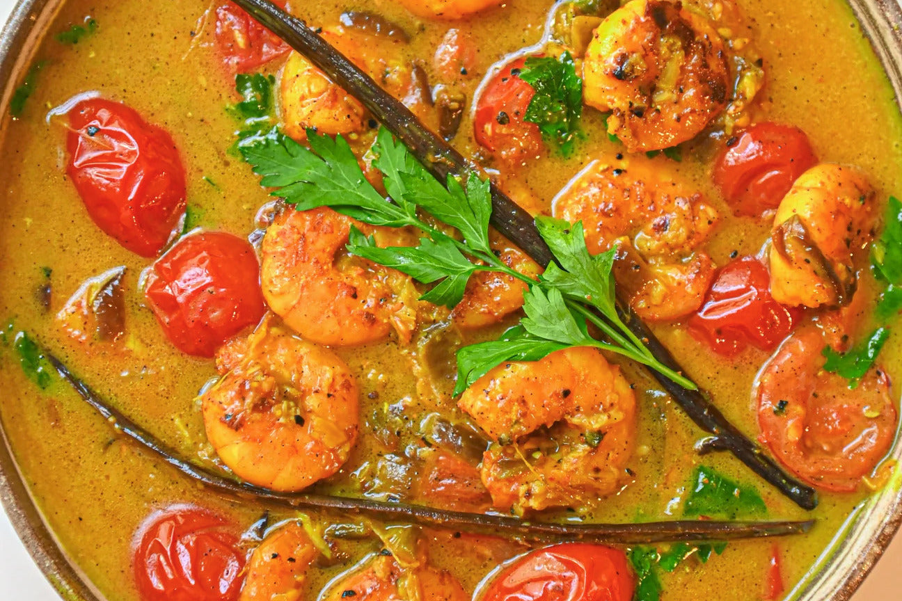 Paradise Prawns With Turmeric, Vanilla Bean And Coconut Curry in a pot.