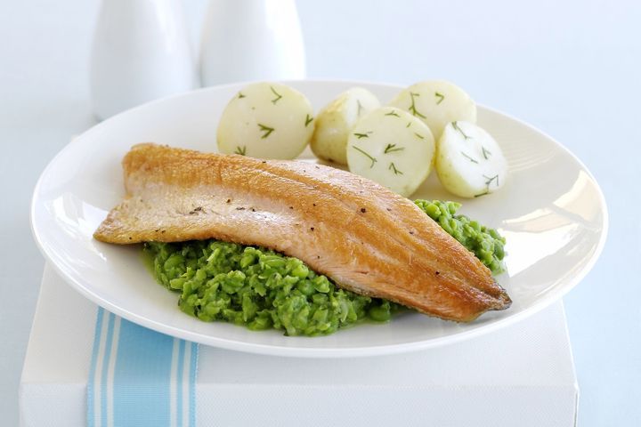 Rainbow Trout With Minted Pea Mash served on a white plate.