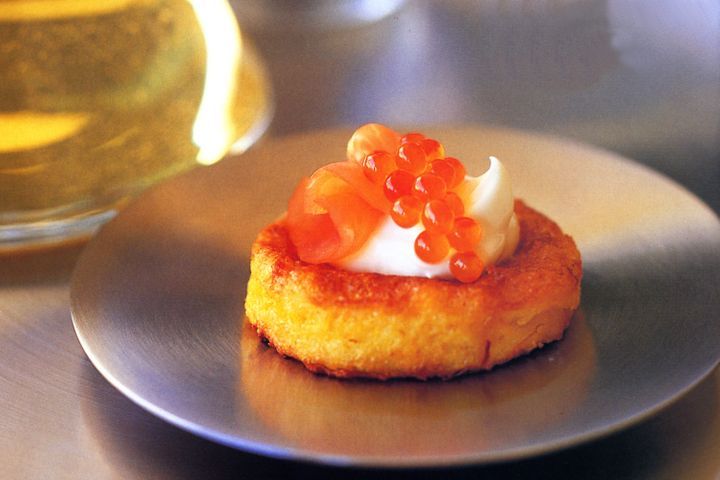 Saffron French toast topped with smoked salmon and salmon roe, served on a plate.