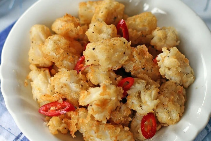 Salt & Pepper Squid displayed on white plate.