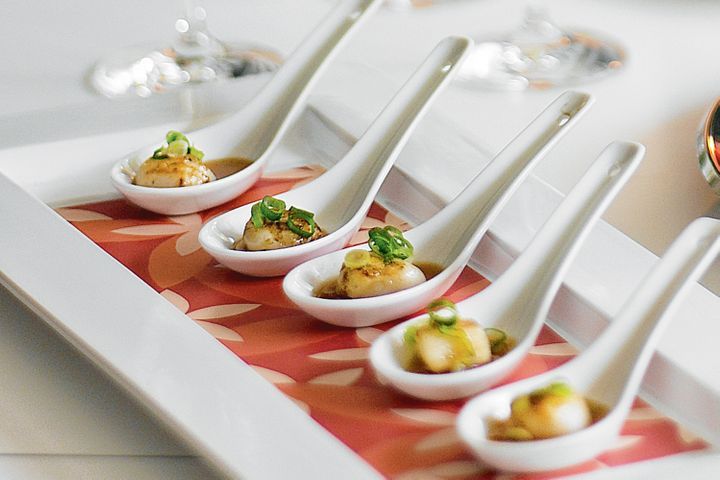 Scallops With Ginger And Shallots presented on spoons.