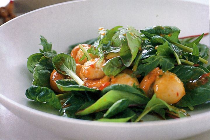 Seared Scallops With Chilli Dressing And Baby Asian Greens served in a bowl.