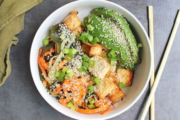Seaweed Salad With Vegetables And Tofu in a white bowl.