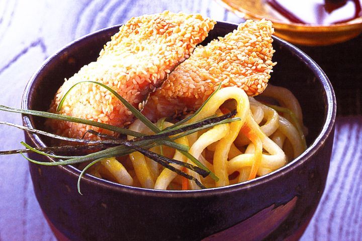 Sesame Crumbed Rainbow Trout On Wasabi Noodles in a bowl.