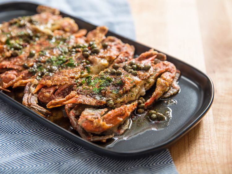 Sautéed Soft-Shell Crabs With Lemon-Butter Pan Sauce on black platter.
