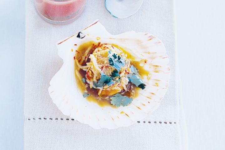 Steamed Scallops With Ginger served in a shell.