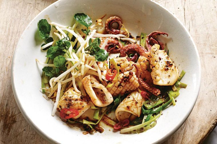 Stir Fried Salt And Pepper Squid With Chilli And Shallots in a white bowl.