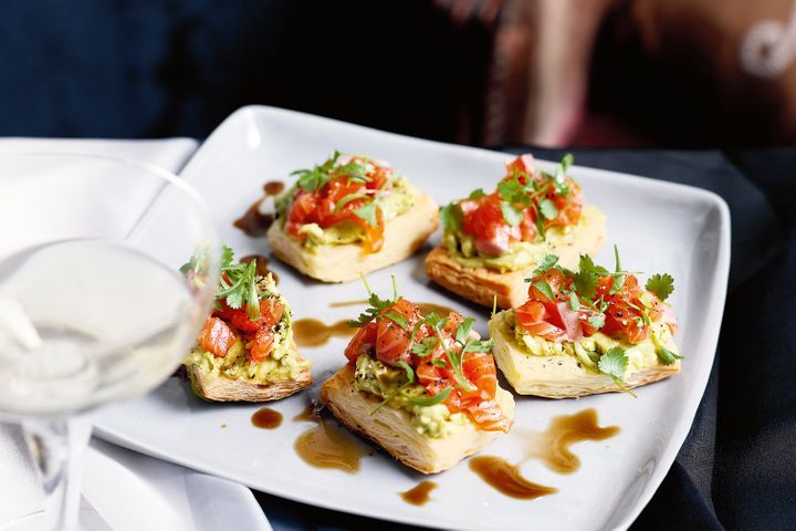 Tartines With Salmon Sashimi And Wasabi Avocado on serving tray.