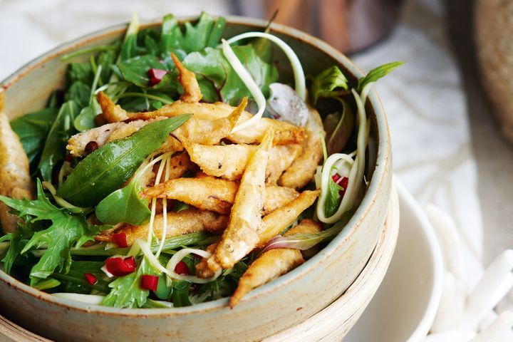 Thai Salad With Crispy Whitebait in a wooden bowl.