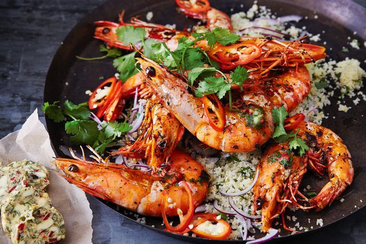 Tiger Prawns With Chermoula Butter on black platter.