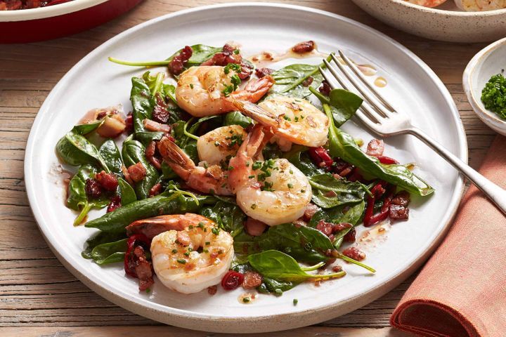 Tiger Prawns With Spinach And Bacon Chilli Vinaigrette displayed on a plate.