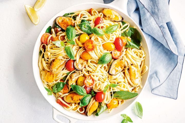 Tomato And Garlic Smoked Mussel Pasta displayed in white bowl.