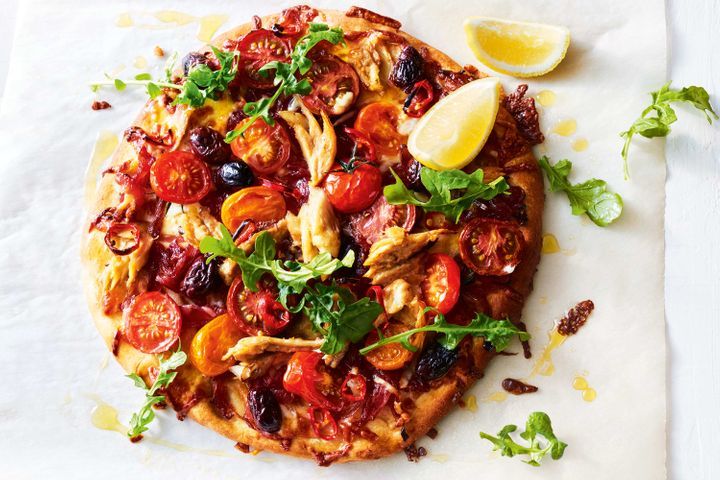 Tomato, Chilli And Mackerel Pizza displayed on table.