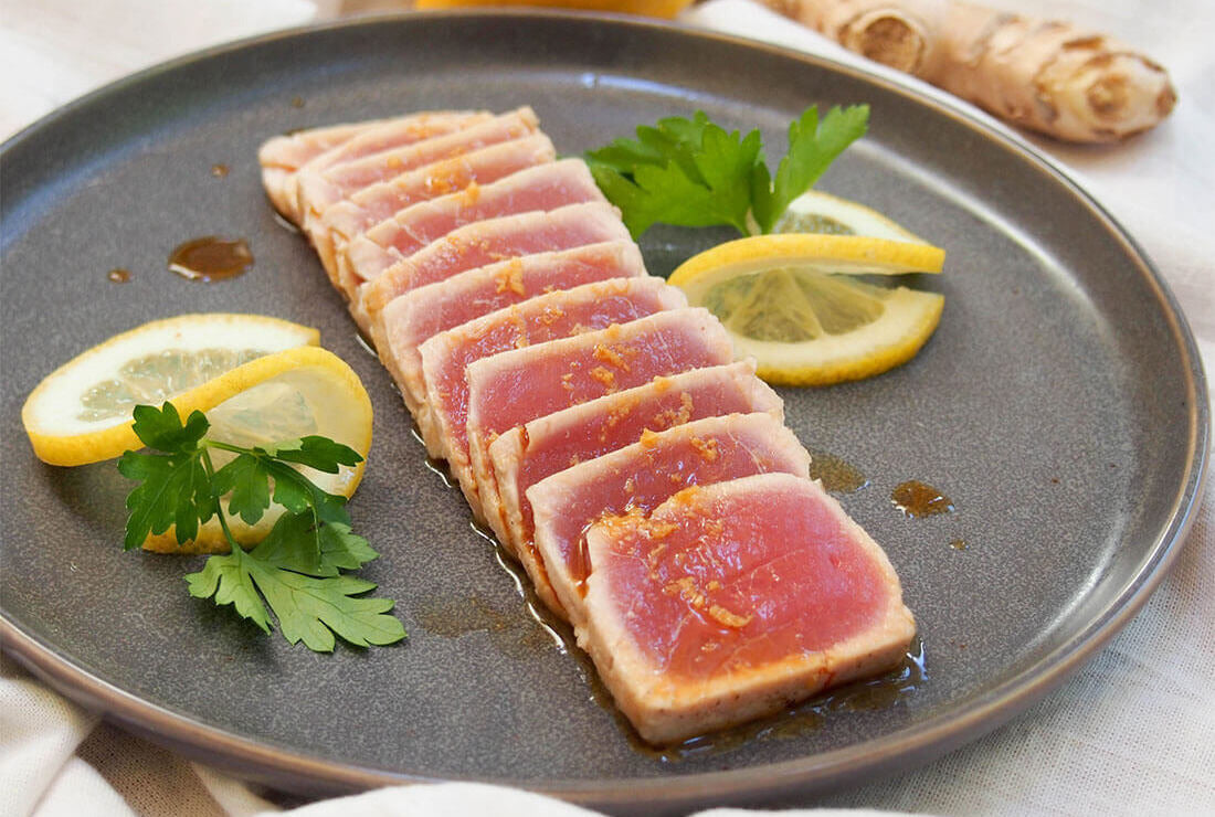 Tuna Tataki displayed on a brown plate.