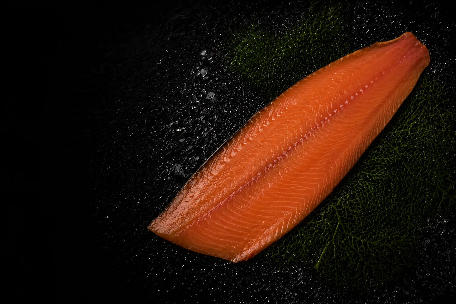 Smokede salmon fillet on a dark surface