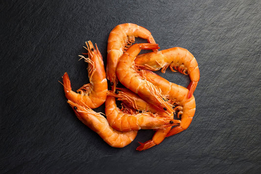 Cooked Vannamei prawns displayed on a black board, ready to order online in Sydney for delivery.