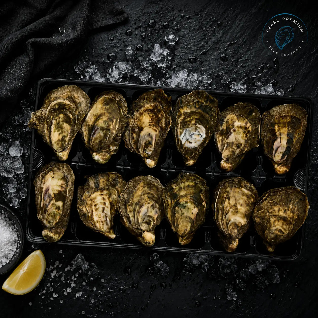 Live pacific oysters arranged in a tray on crushed ice with lemon