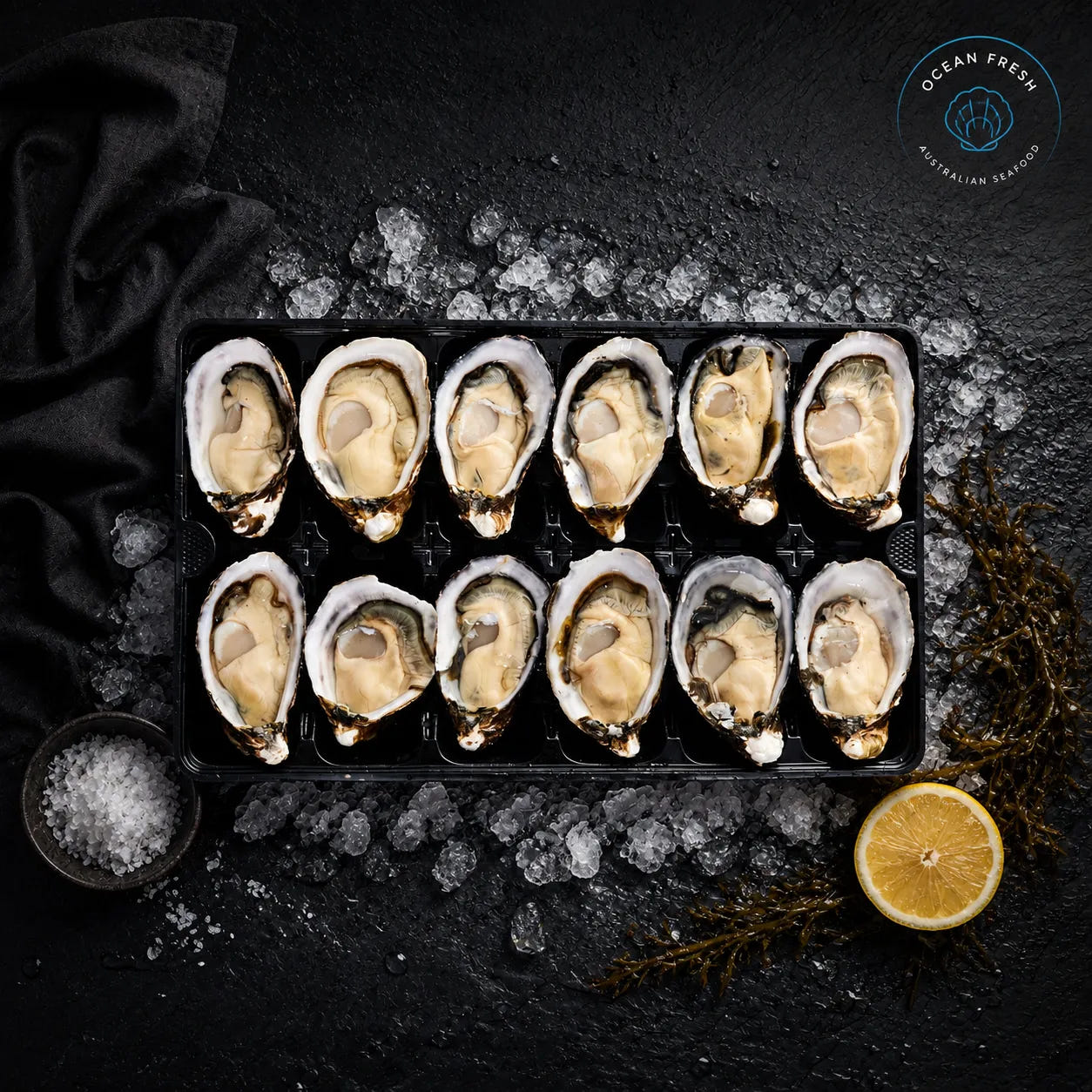 Fresh pacific oysters arranged in a tray on crushed ice with lemon